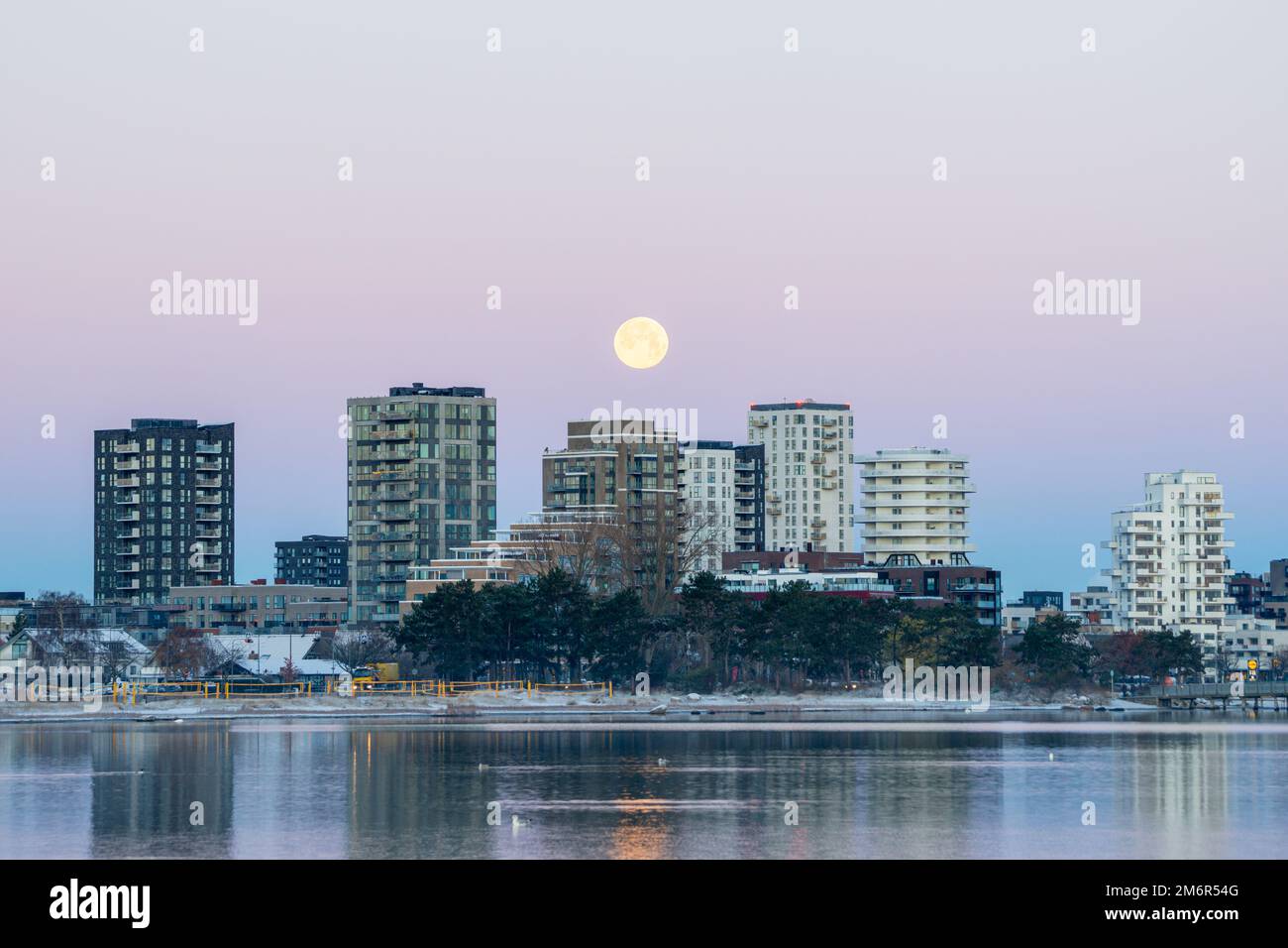 Amager Strandvej, Copenhagen, Denmark. Tower blocks near the Amager Strandpark eastern side of the city, with the full moon and visible belt of venus Stock Photo