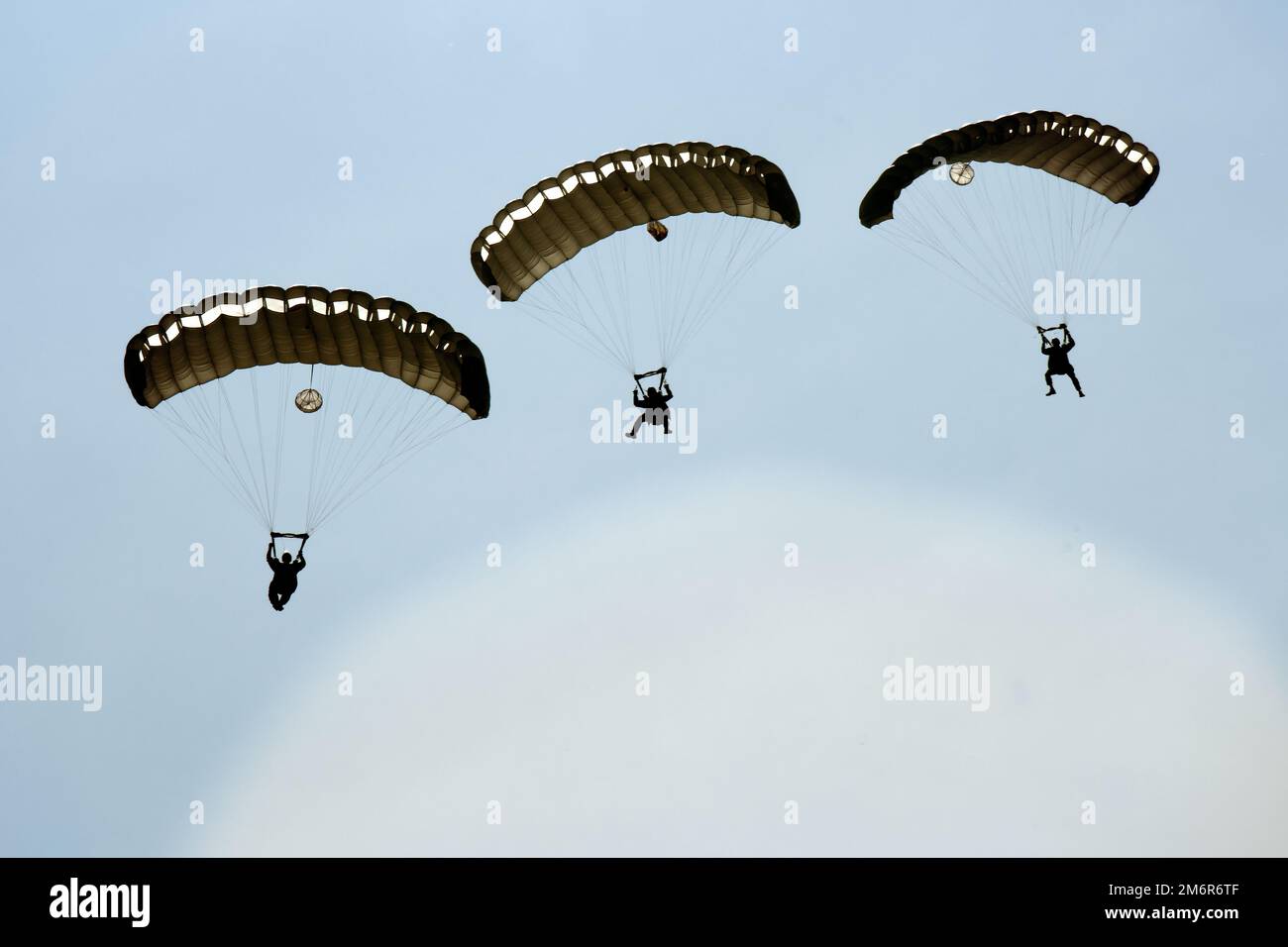 A U.S. Air Force Combat Control Team with the 352d Special Operations Wing performs a military free fall over Powidz Air Base, Poland, May 4, 2022. The training was part of Trojan Footprint 22, the premier SOF exercise in Europe that focuses on improving the ability of SOF to counter myriad threats, increases integration with conventional forces and enhances interoperability with NATO allies and European partners. Stock Photo