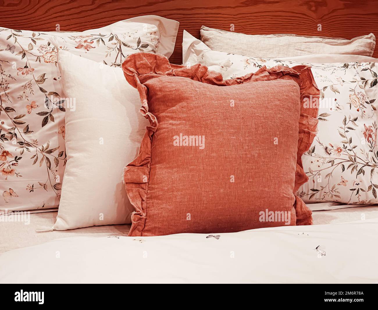 Vintage countryside style bedding with floral pattern on wooden bed in