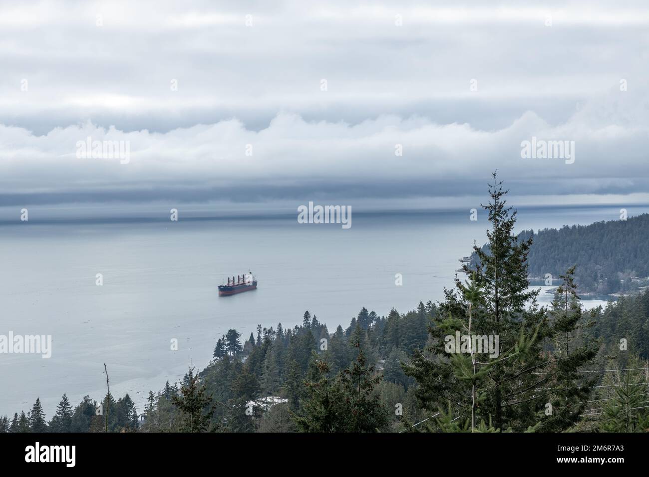 View of The Cypress Pop-up Village lookout with Burrard Inlet and a large ship in the background Stock Photo