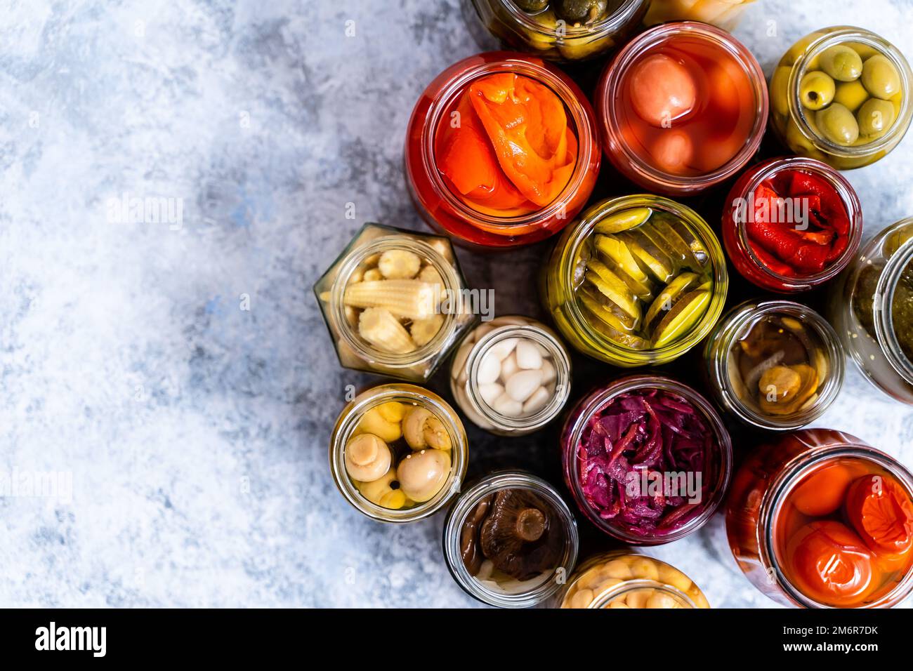 https://c8.alamy.com/comp/2M6R7DK/cucumber-pepper-tomatoes-mushrooms-pickling-and-canning-into-glass-jars-ingredients-for-vegetables-preserving-2M6R7DK.jpg