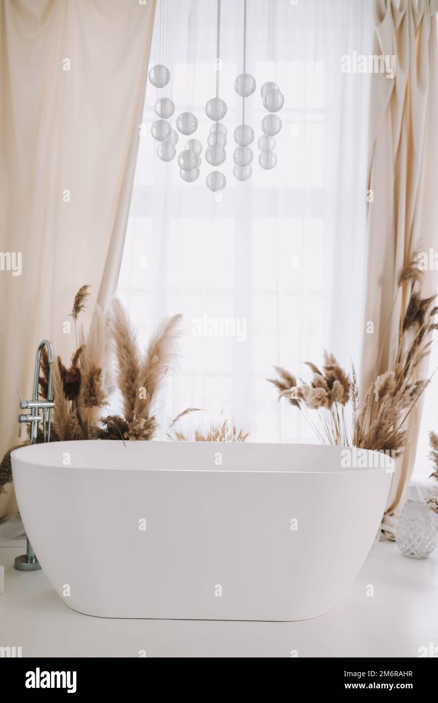 Modern white bathroom. White bath in a room with white walls. Interior