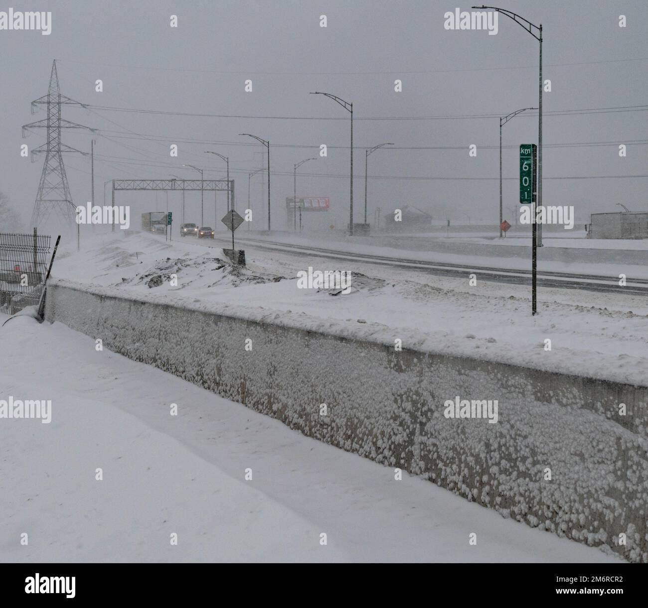 Road under the snow. Close-up of snow on the road. Impossibility of taking a vehicle. Snow storm. Transport impossible with snow. Road with snow. Stock Photo