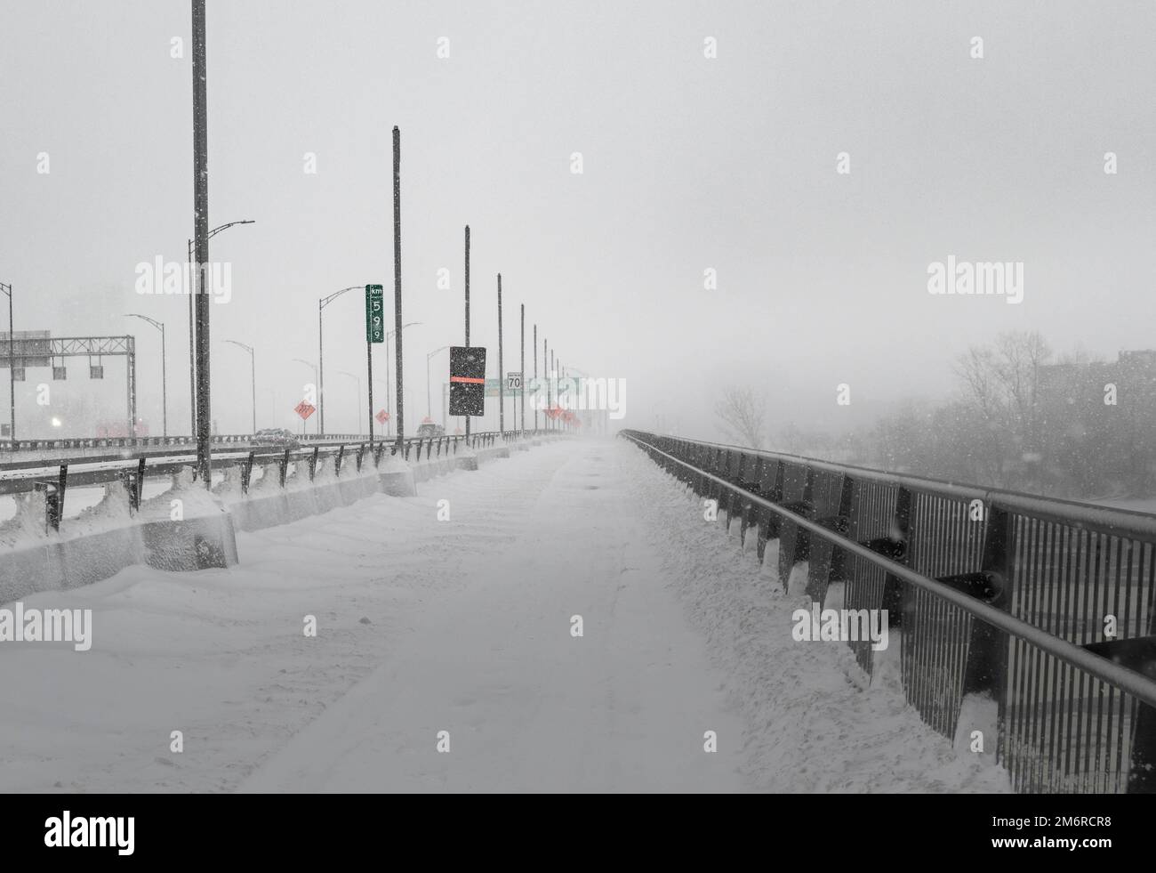 Road under the snow. Close-up of snow on the road. Impossibility of