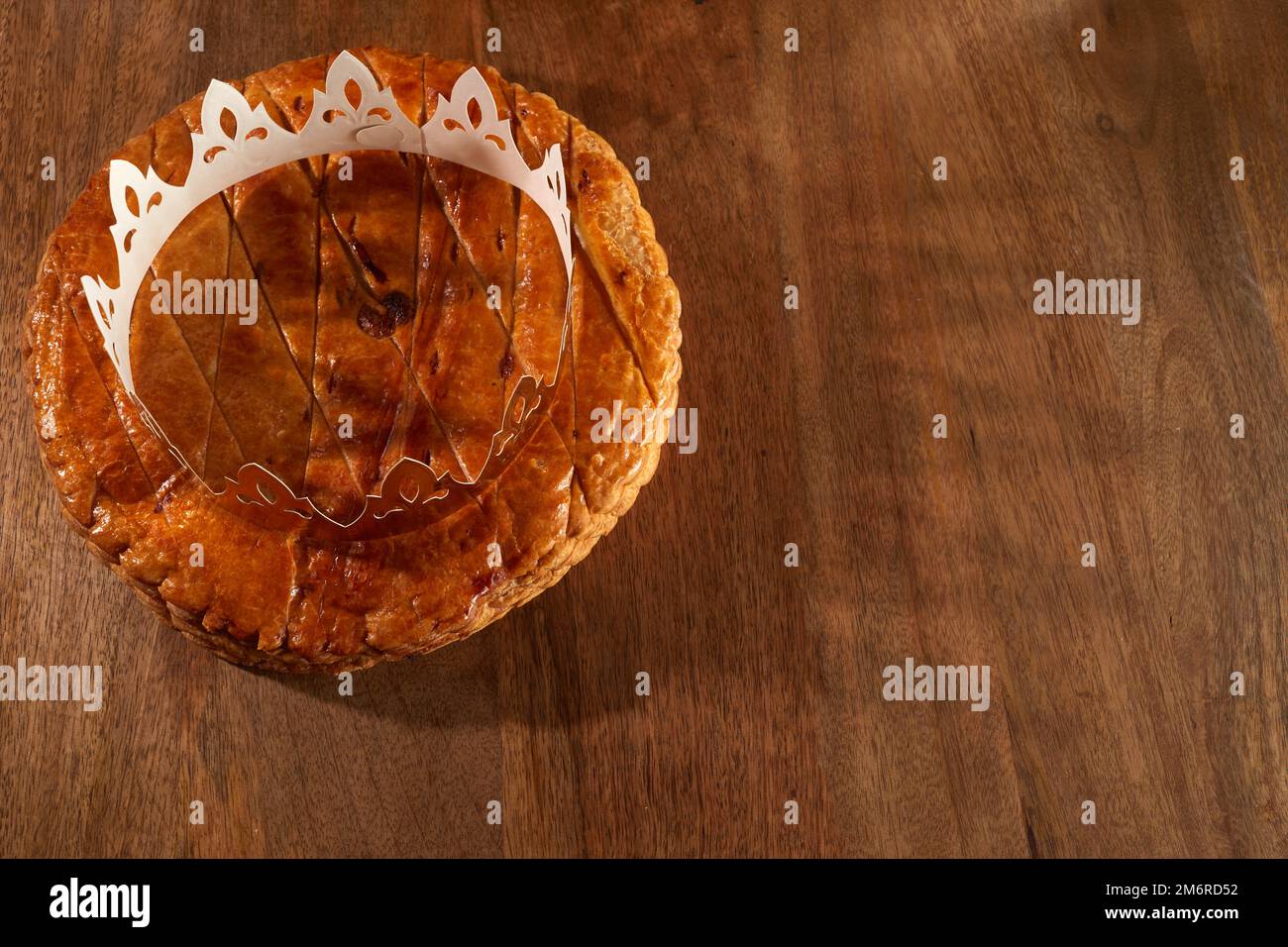 King cake or galette des rois in French. Epiphany pie with golden paper
