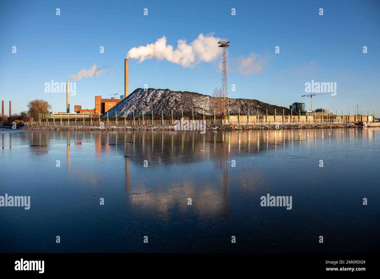 Hanasaari coal-fired cogeneration power plant coal stock on a clear winter day in Helsinki, Finland Stock Photo