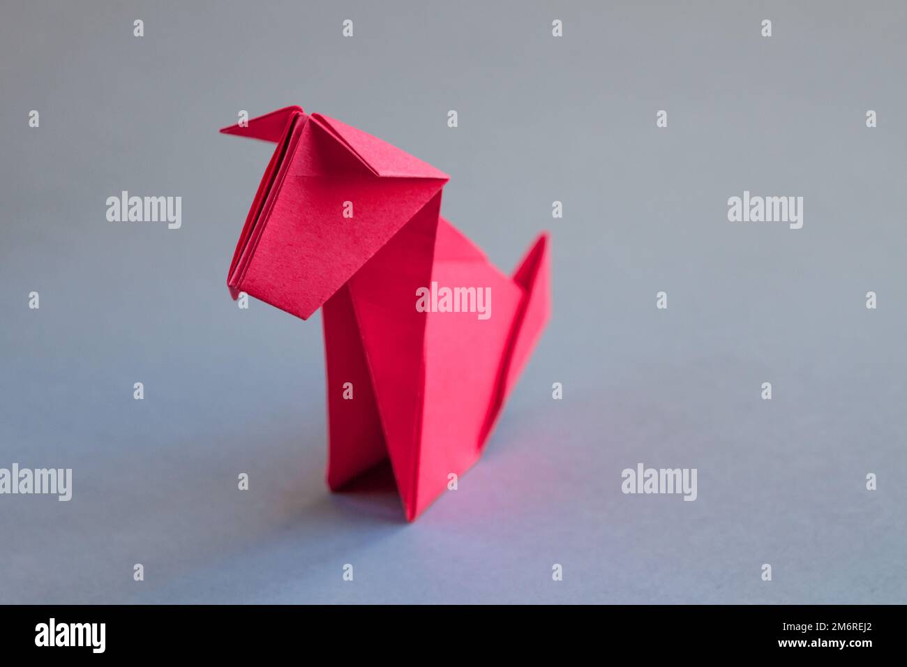 Red paper dog origami isolated on a grey background Stock Photo
