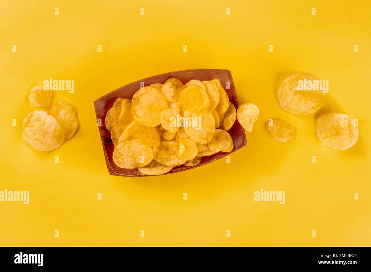 Potato chips or crisps, a salty snack in a bowl, overhead flat lay shot