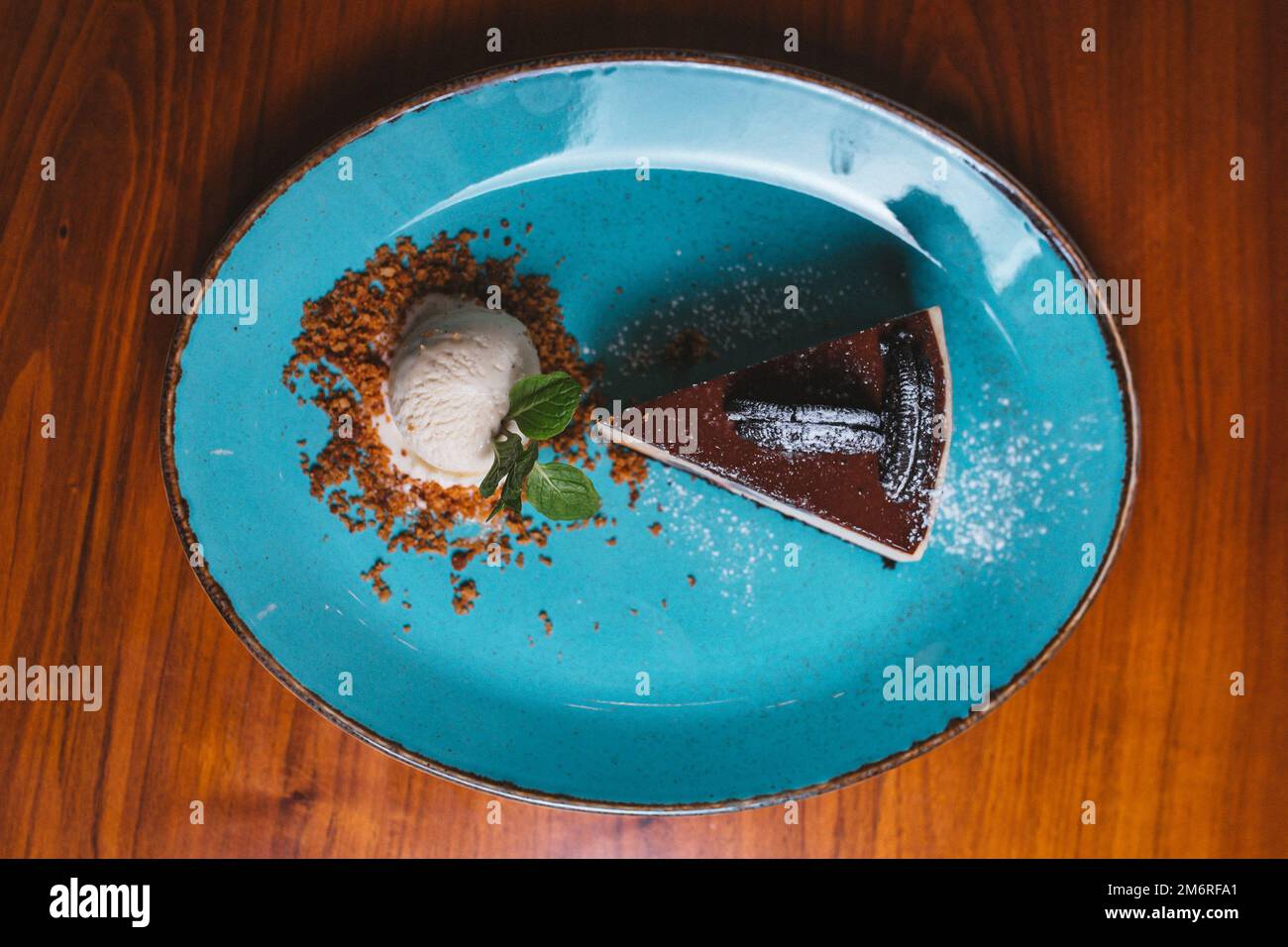 Chocolate cake with cookies and a scoop of vanilla ice cream top view