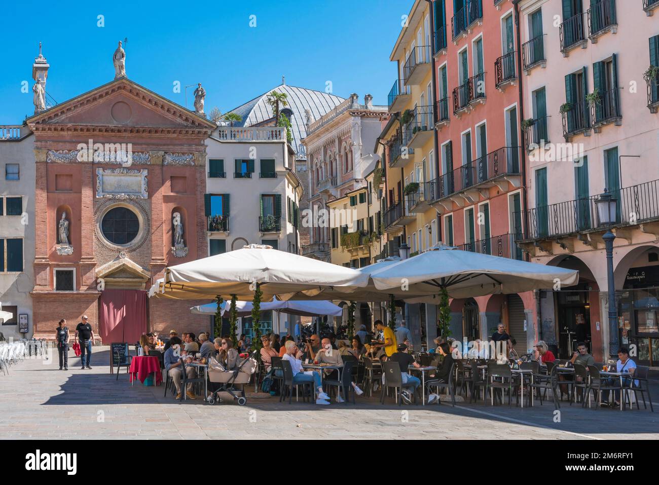Cafe piazza Italy, view in summer of people dining at cafe tables in the Piazza dei Signori in the scenic and historical center of Padua, Veneto,Italy Stock Photo