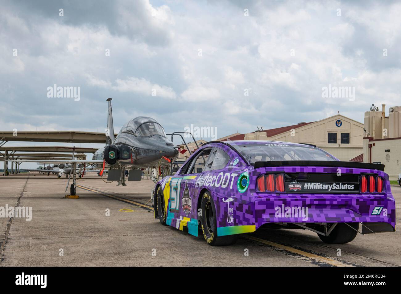 Rick Ware Racing’s NASCAR Cup Series number 51 show car sits nose-to-nose with a T-38 Talon at Joint Base San Antonio-Randolph, Texas, May 4, 2022. The car and racing crew toured JBSA over three days giving service members and their families an up-close look as part of their Military Salutes Program. Stock Photo