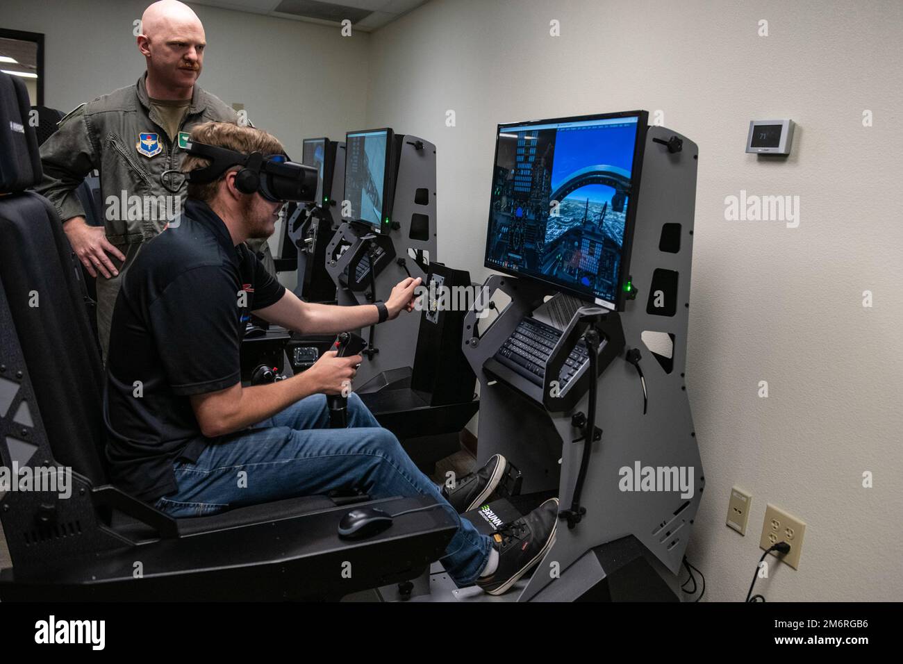 Garrett Smithley, driver for Rick Ware Racing’s NASCAR Cup Series, flys a T-38 Talon simulator at the 12th Flying Training WIng on Joint Base San Antonio-Randolph, Texas, May 4, 2022. Smithley, his racing crew and his show car toured JBSA over three days giving service members and their families an up-close look as part of their Military Salutes Program. Stock Photo