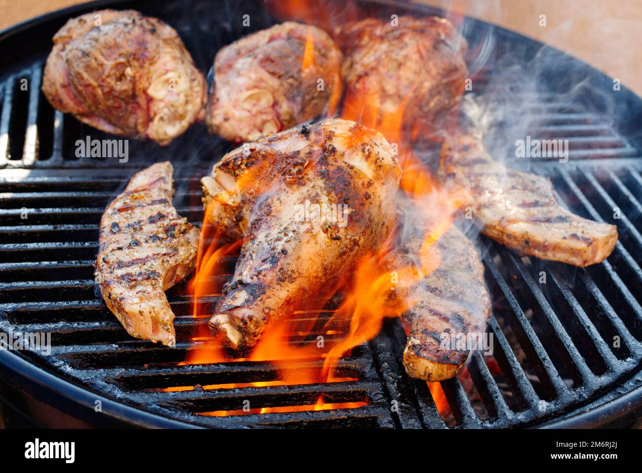 Traditional barbecue lamb shanks and saddle grilled as closeup on a