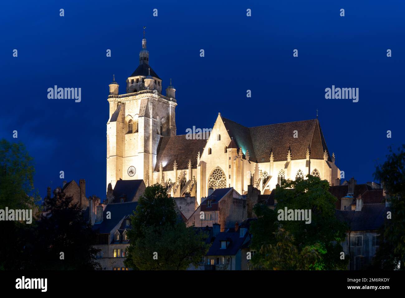 View of the illuminated Notre Dame catholic church in the city center of Dole  at night Stock Photo