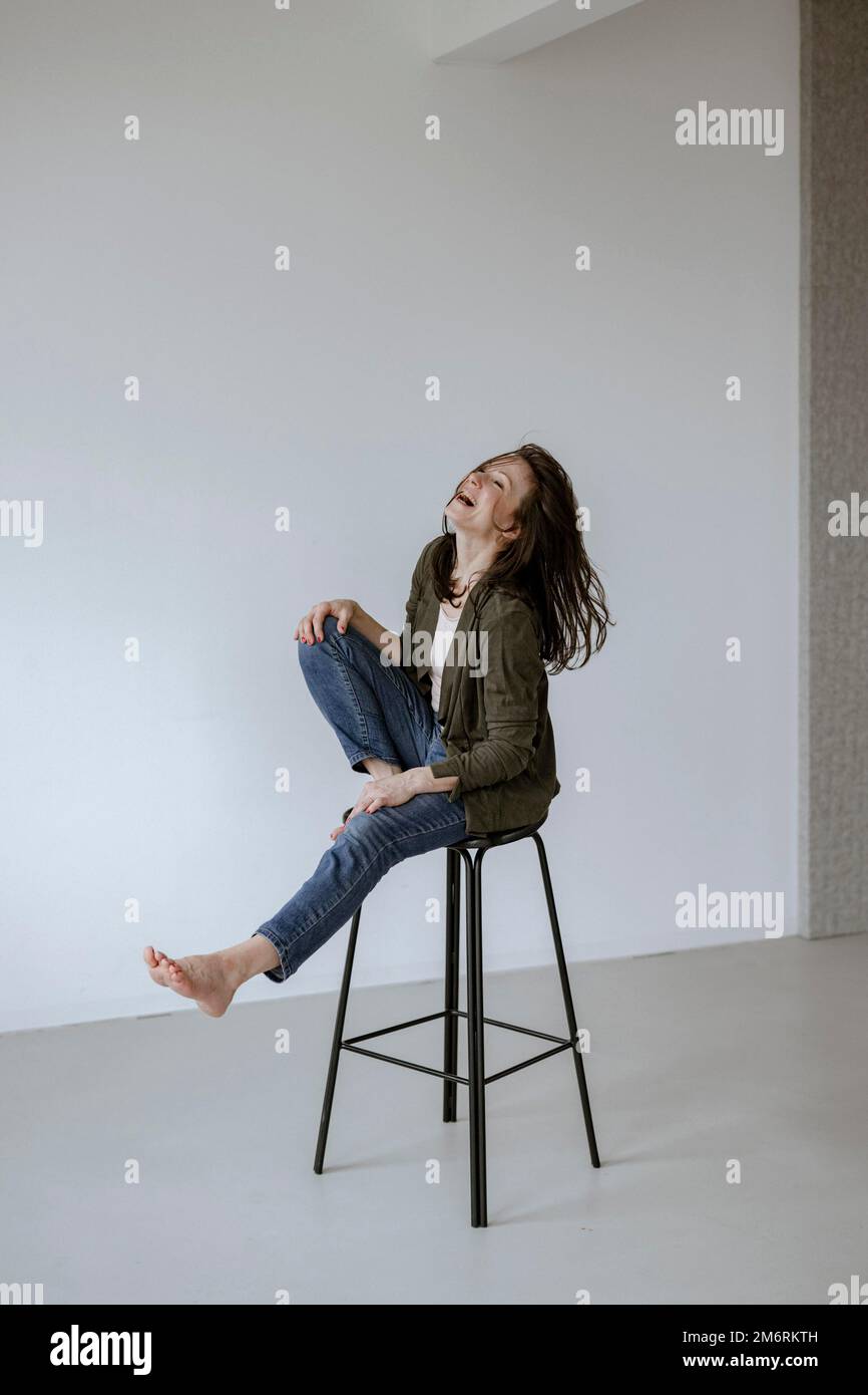 Woman chair barefoot hi-res stock photography and images - Alamy