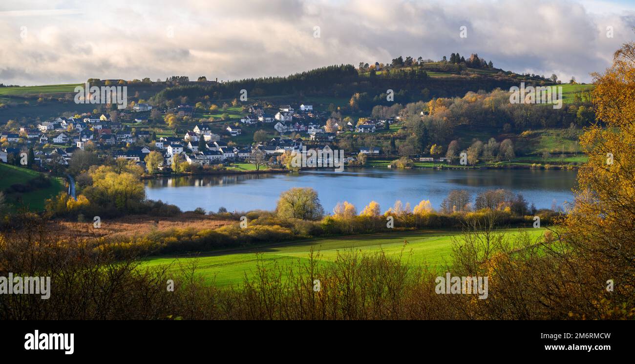 Hillside town of Schalkenmehren with volcanic lake and observatory in fall Stock Photo