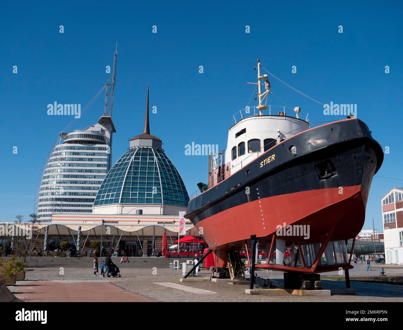 Tugboat Stier in the German Maritime Museum and in the background the glass dome of the restaurant and modern futuristic skyscrapers ATLANTIC Hotels Stock Photo