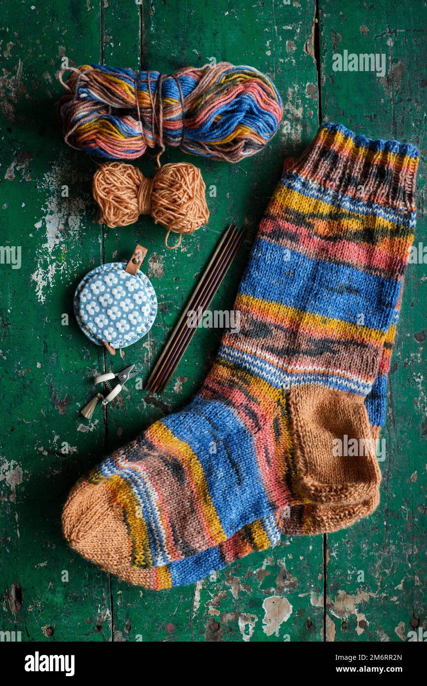 Handwork knitting socks with knitting needles wool and tape