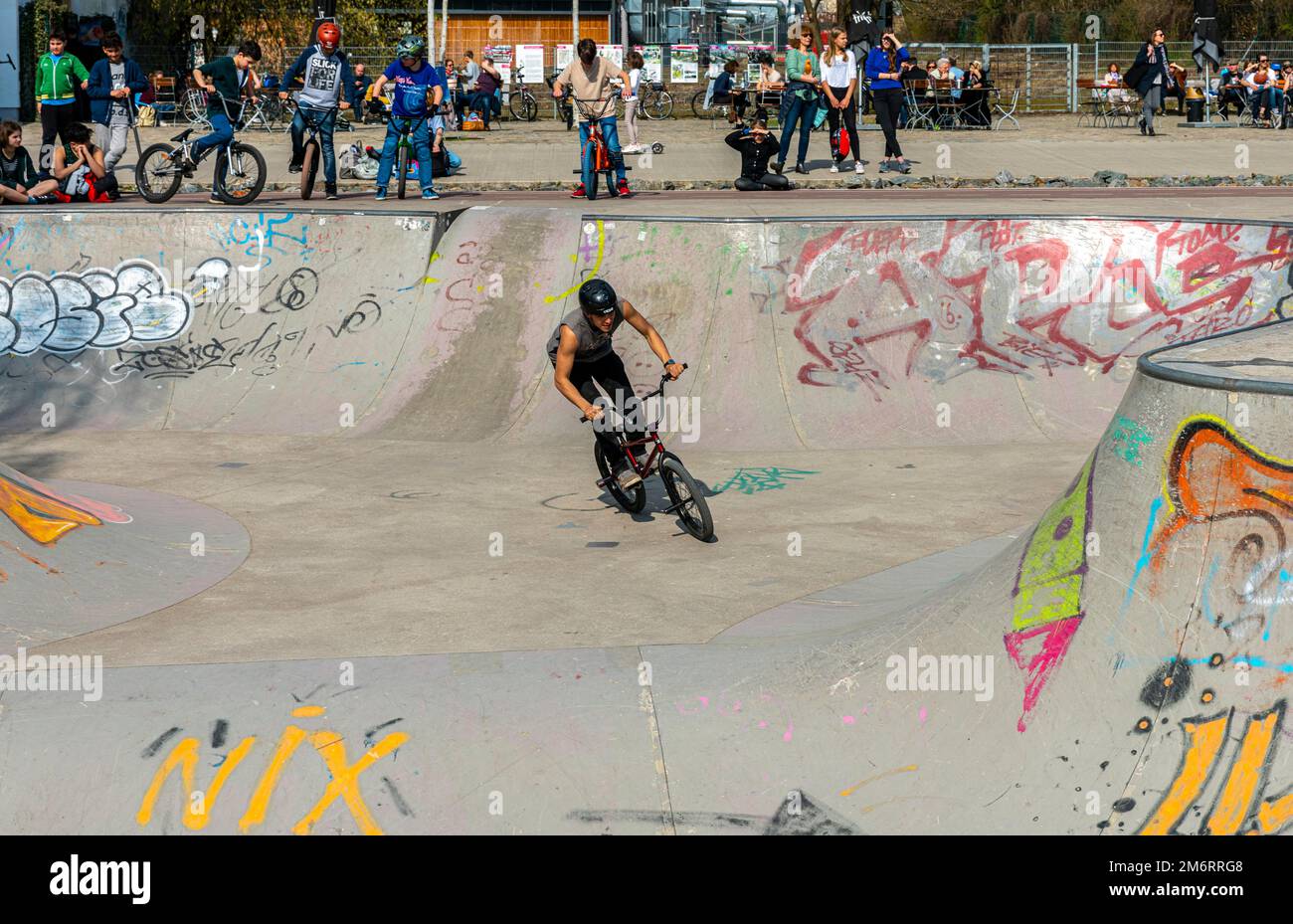 Skateboarders and cyclists at a skate pool in the Park am Gleisdreieck in Berlin-Mitte, Berlin, Germany Stock Photo