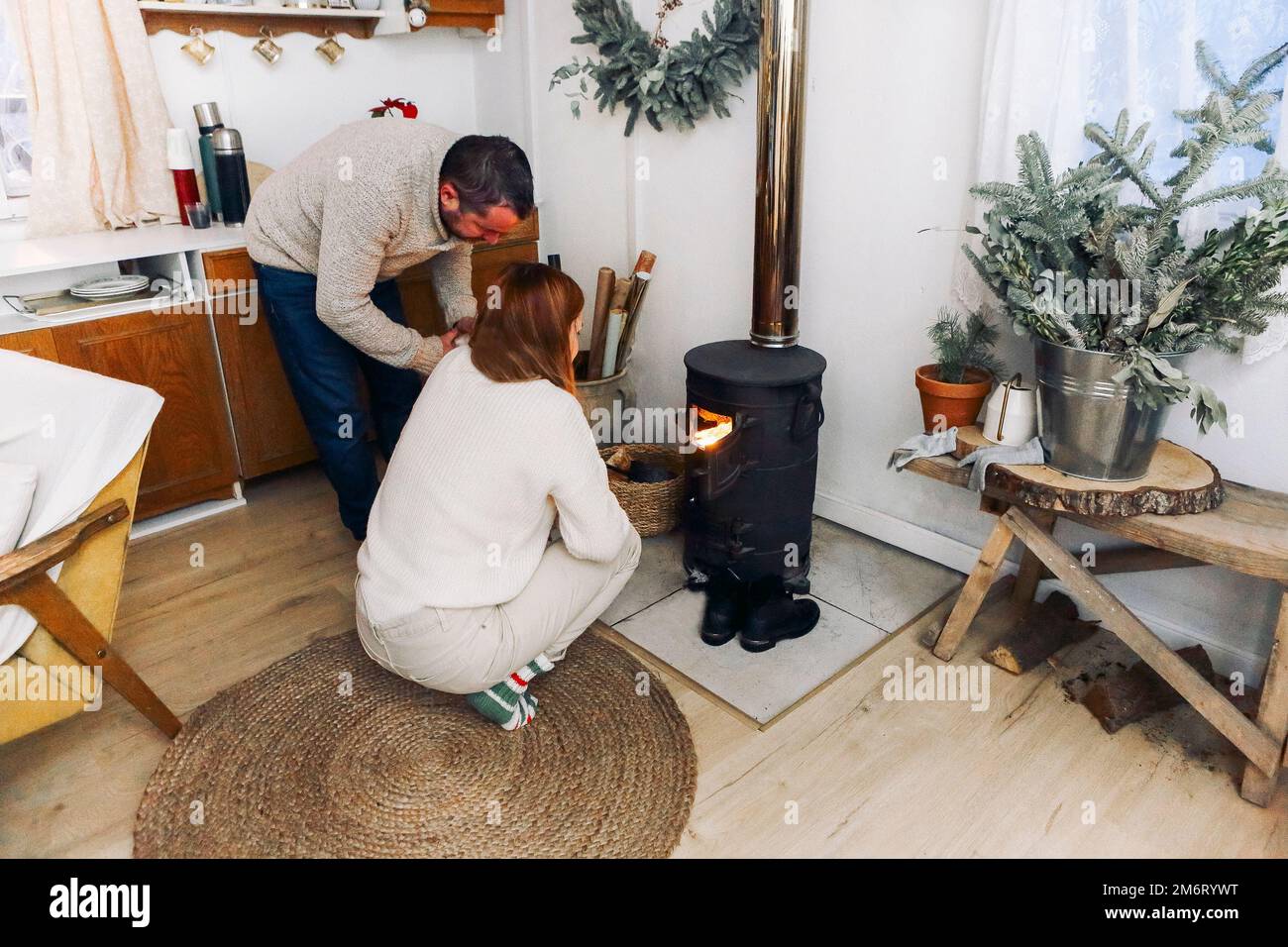 Photo of coule in warm woolen socks over fire place. Hygge concept