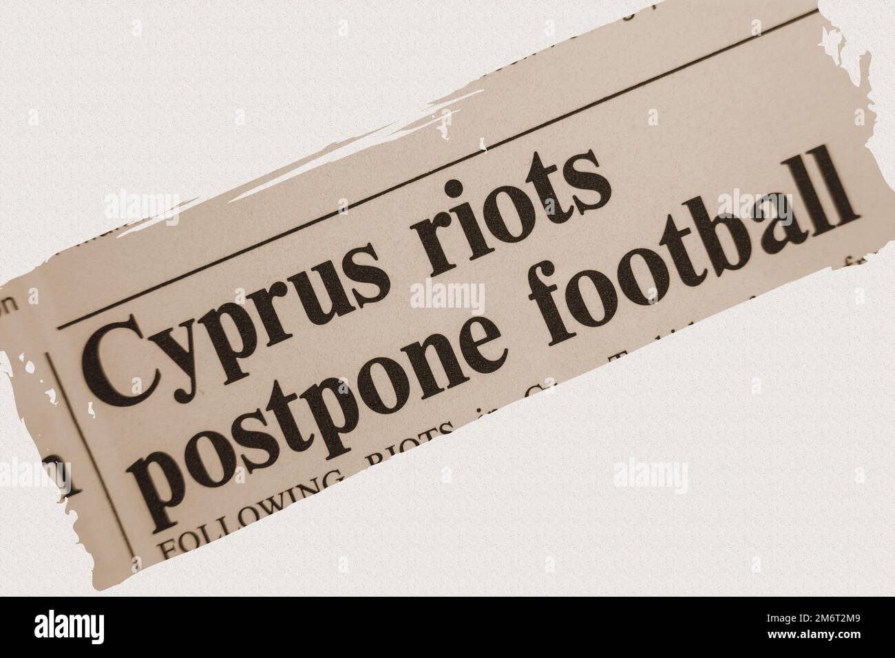 news story from 1975 newspaper headline article title - Cyprus riots postpone football - overlay sepia Stock Photo