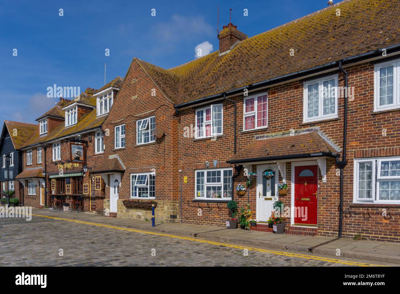 Red brick rowhouses on the harborfront of Folkestone Stock Photo
