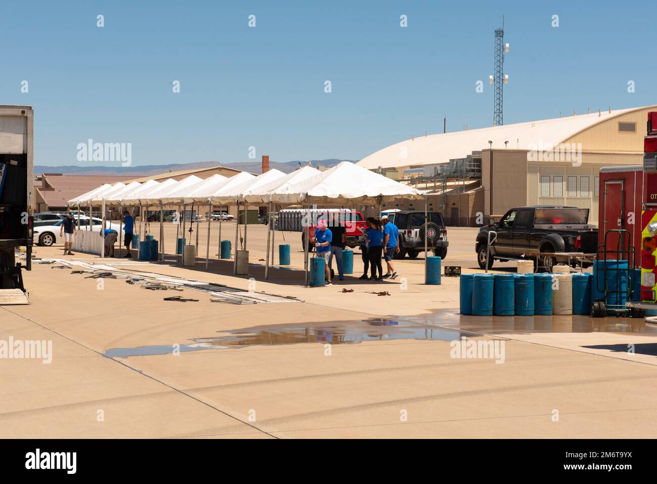 Volunteers and Airmen set up tents on the flightline, May 5, 2022, on