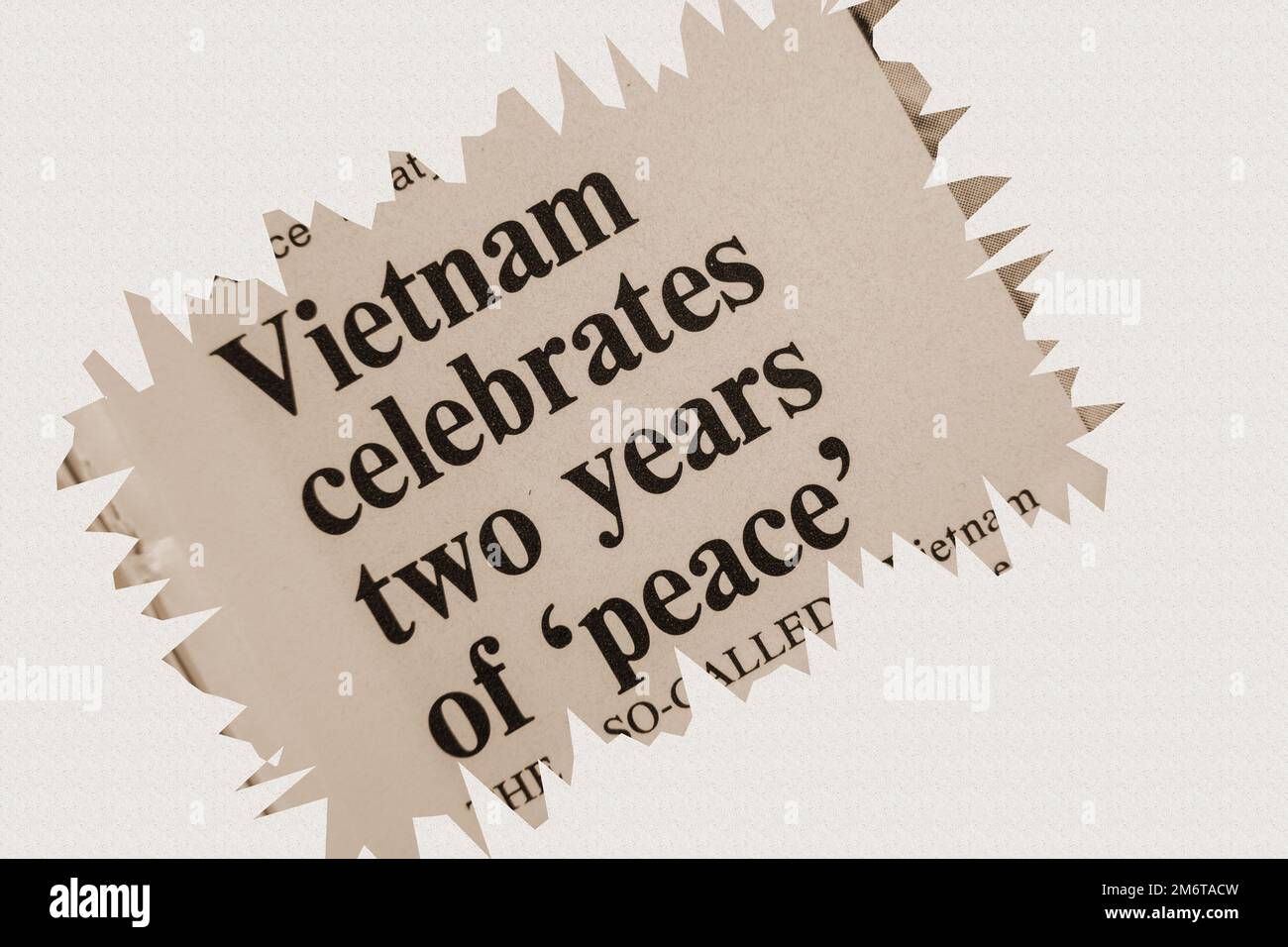 news story from 1975 newspaper headline article title - Vietnam celebrates two years of peace - overlay sepia Stock Photo