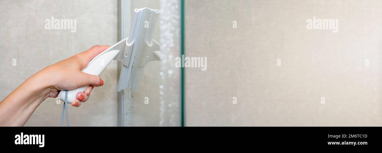 Shower cabin cleaning. Cleaning glass after using the shower. Cleaning
