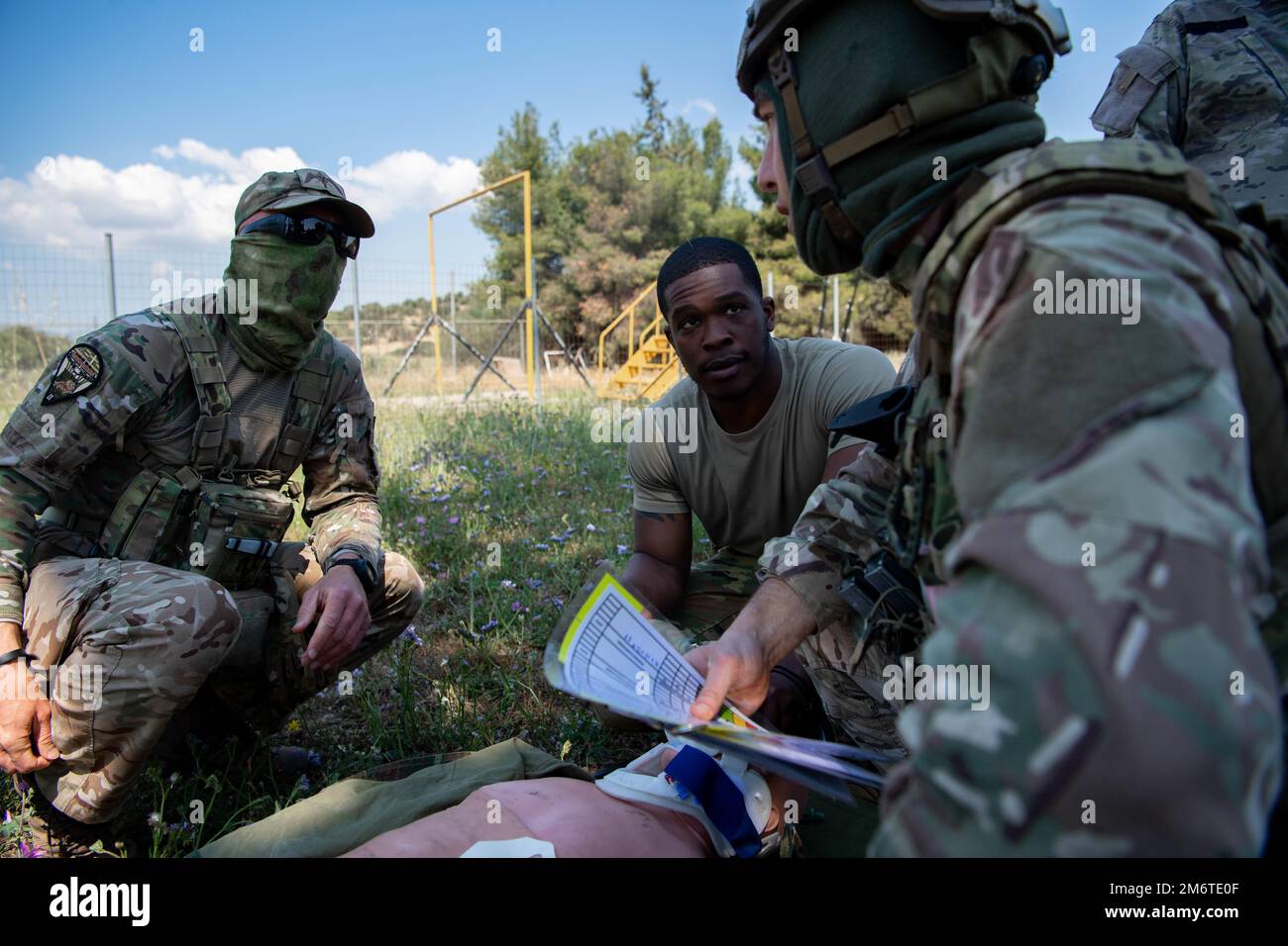 U.S. Air Force Staff Sgt. Kamarley Campbell assists Hellenic Air Force members during simulated aeromedical evacuation during Stolen Cerberus IX at Elefsina Air Base, Greece, May 5, 2022. Campbell assisted in providing oxygen to patients after only gaining minimal injuries during the simulation. Stolen Cerberus improves overall coordination with allies and partner militaries, assuring the U.S. commitment to increasing the alliance's forces' capability, readiness, and responsiveness. Stock Photo