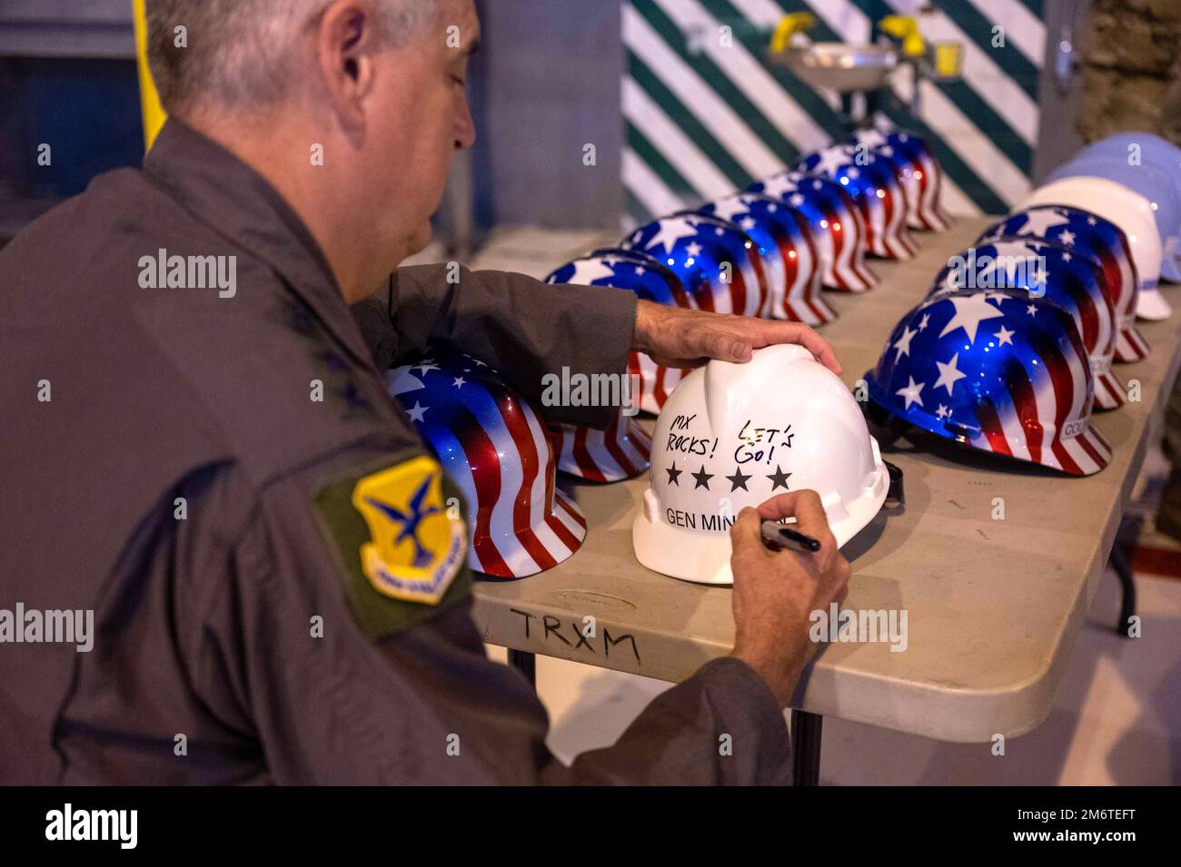 Gen. Mike Minihan, Air Mobility Command commander, signs a safety