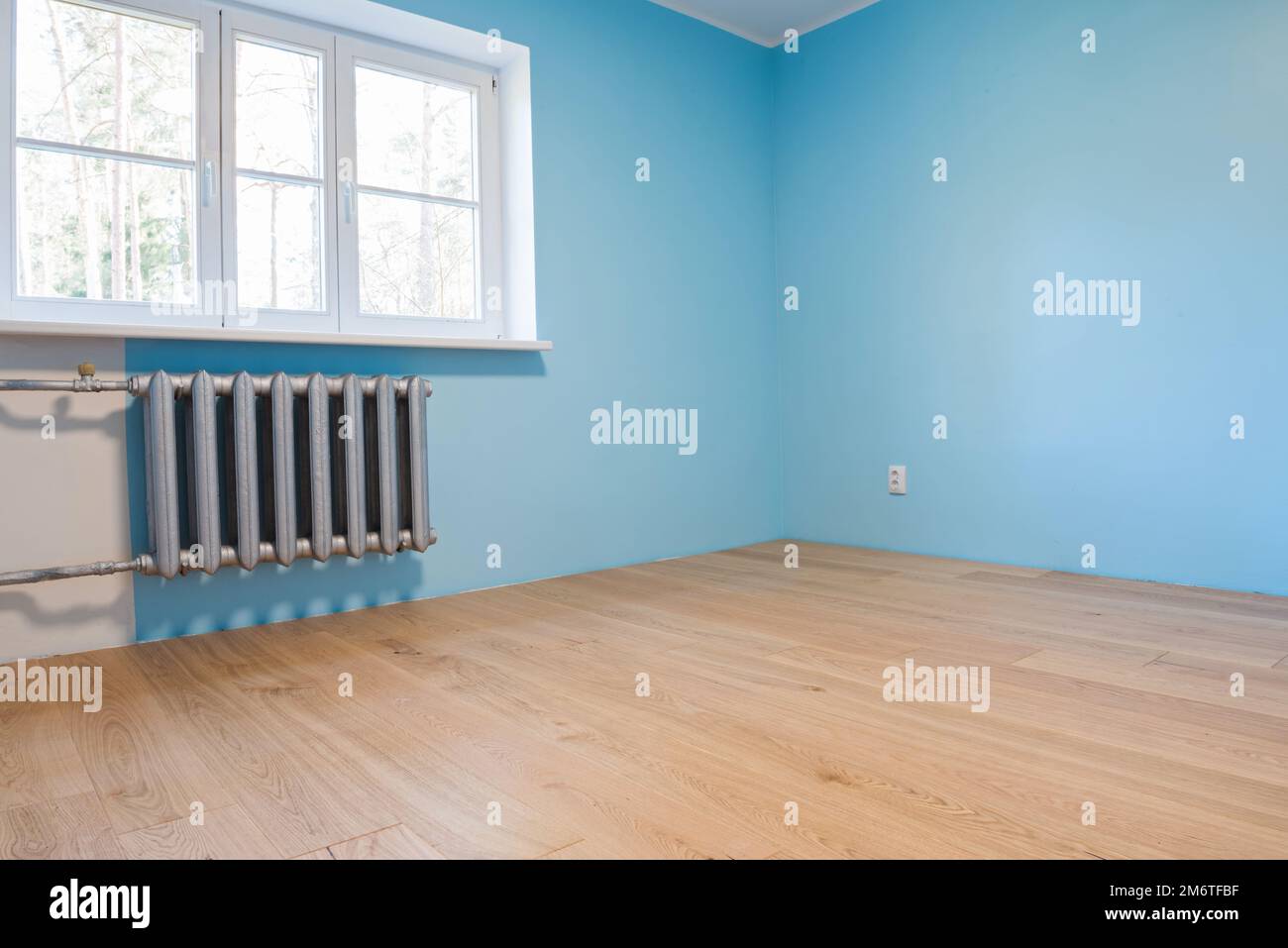 New home construction interior room with wooden floors and windows Stock Photo