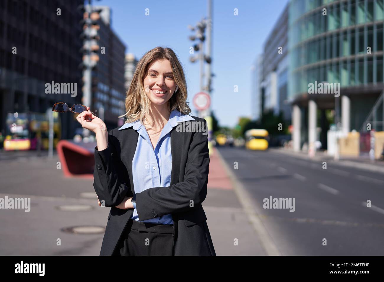 Portrait of successful young company ceo, businesswoman in black suit