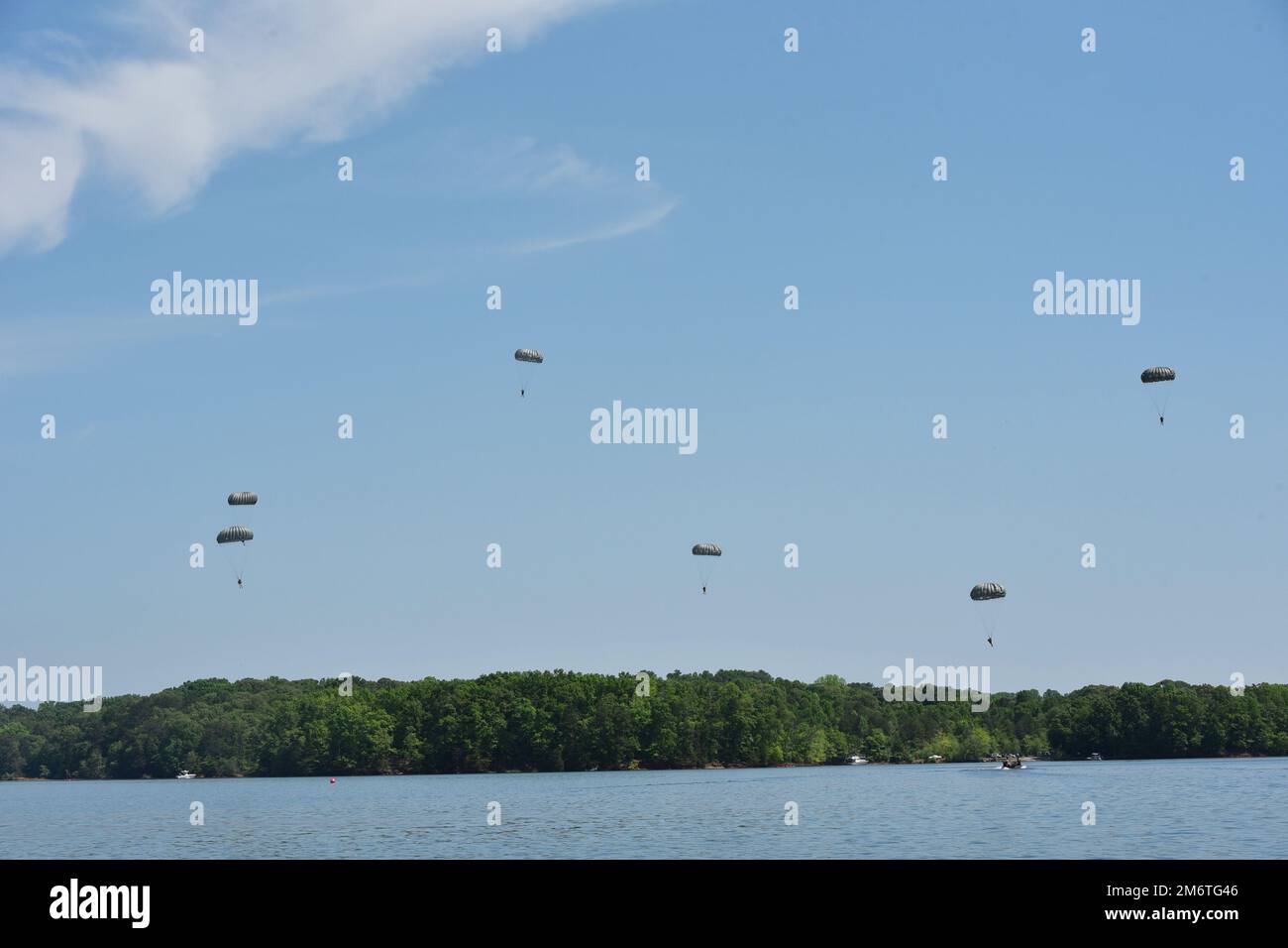 Soldiers from the 5th Ranger Training Battalion parachute into Lake Lanier, Georgia, May 5, 2022. This training involves jumpers practicing with a parachute coming down over their head in the water, surfacing and swimming out. Stock Photo