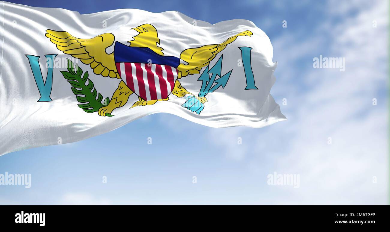 Flags of United States Virgin Islands waving in the wind with the US flag on a clear day Stock Photo