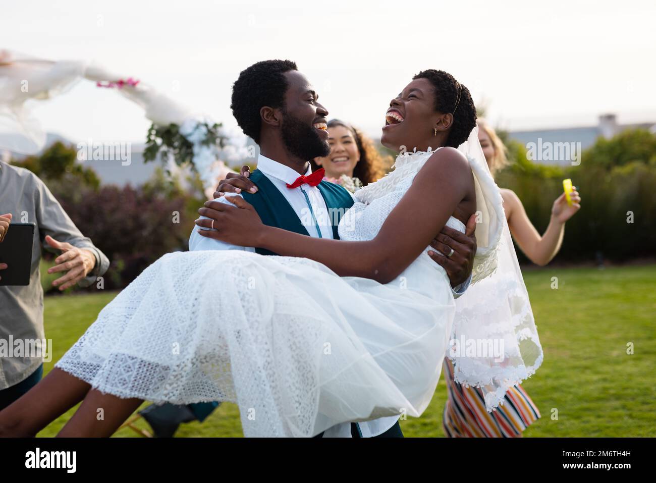Happy african american couple smiling and carrying during wedding Stock ...