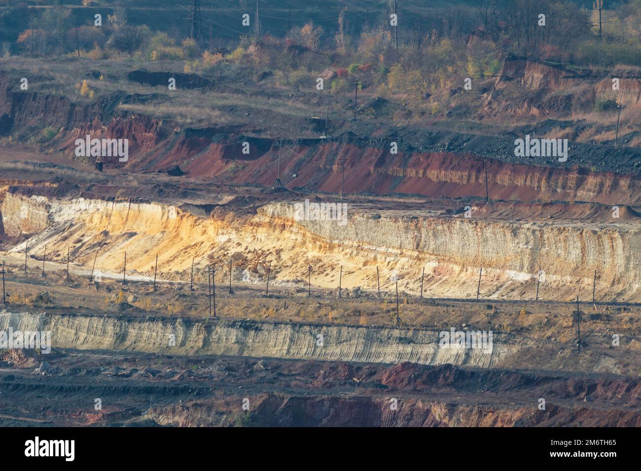 Bright distant quarry landscape at the daylight. Mining iron ore breed