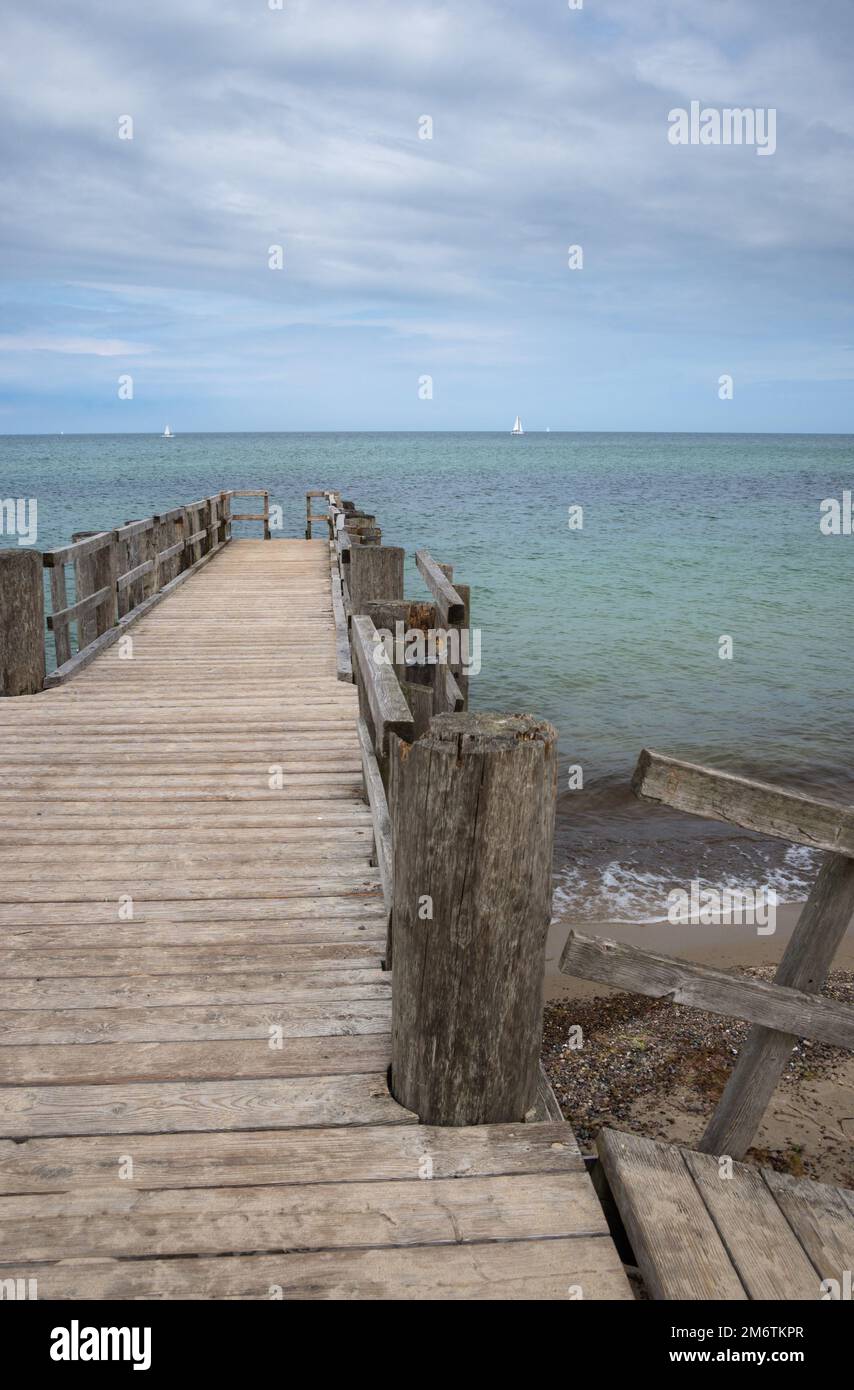 Old empty wooden pier over the sea shore with copy space Stock Photo