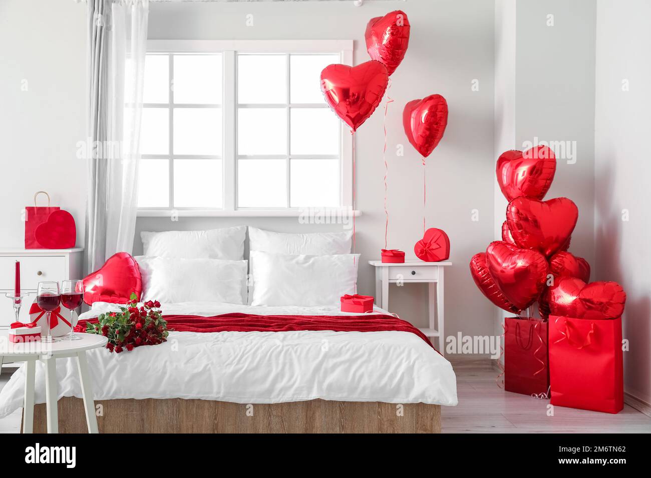 Interior of bedroom decorated for Valentine\'s Day with balloons ...