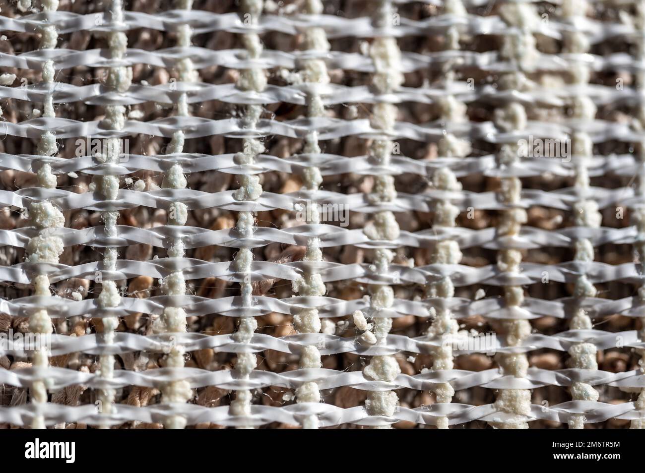 Selective focus on woven polypropylene layer backing of carpet used to  provide support to fabric Stock Photo - Alamy