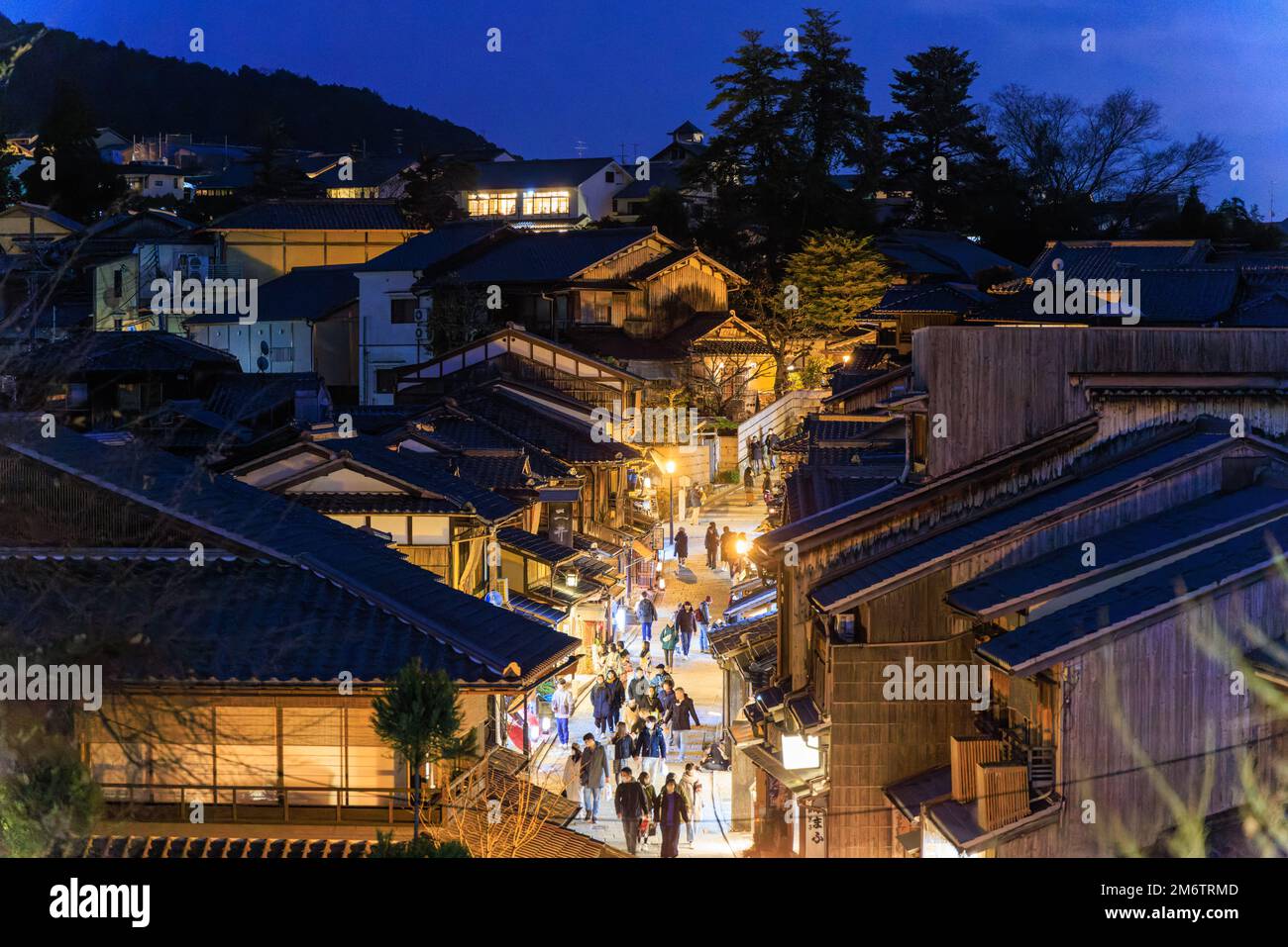 Kyoto, Japan - January 1, 2023: Tourists walk down busy shopping street in Higashiyama at night Stock Photo