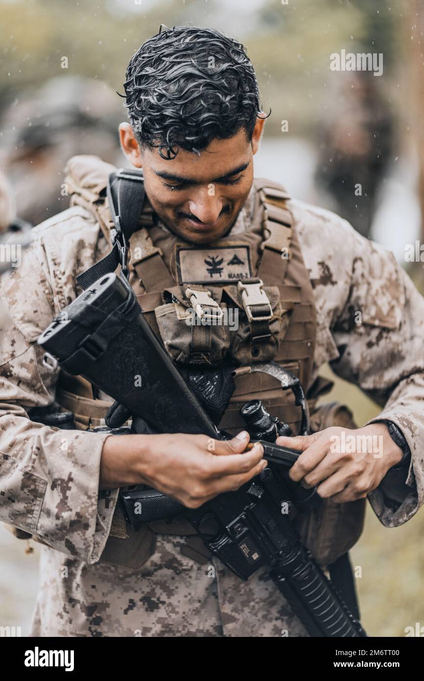 A U.S. Marine With Marine Air Support Squadron (MASS) 2 Loads An M16A4 ...