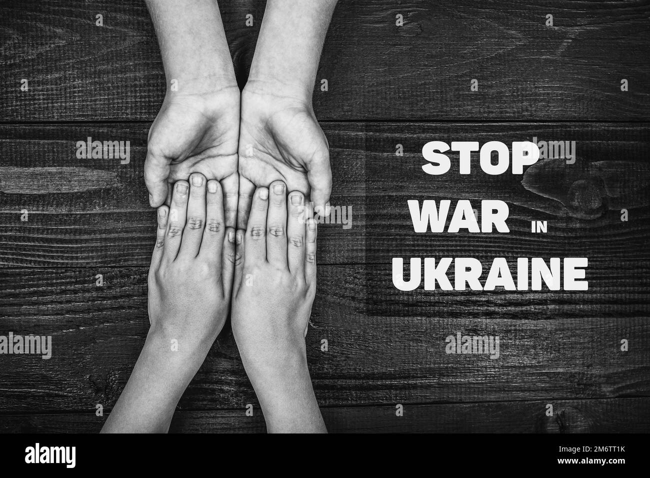 hands holding each other with words stop war Stock Photo