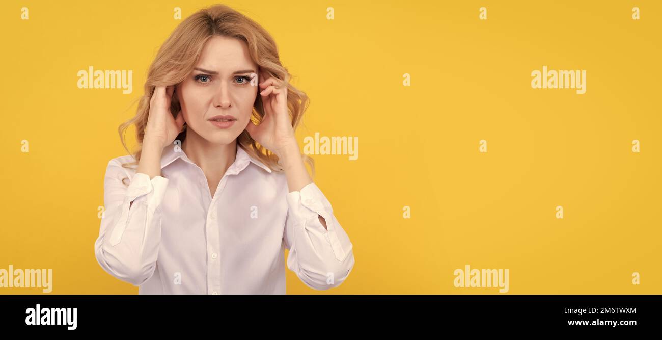 Unhappy ill woman touch ears suffering from ear pain yellow background, earache. Woman isolated face portrait, banner with mock up copy space. Stock Photo