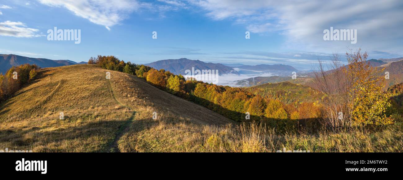 Foggy early morning autumn mountains scene. Peaceful picturesque traveling, seasonal, nature and countryside beauty concept scen Stock Photo