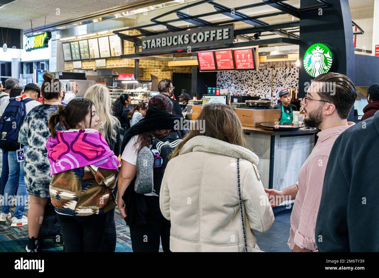 Miami Florida,MIA International Airport,terminal concourse gate area,Starbucks Coffee barista baristas,USA US United States America,North American Ame Stock Photo