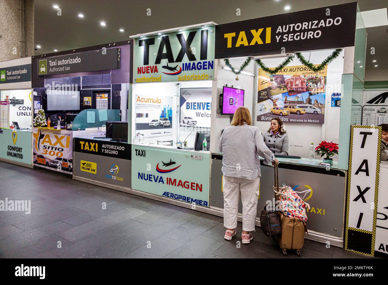 Mexico City,Aeropuerto Internacional Benito Juarez International Airport,terminal concourse gate area,taxi service ordering taxicab,woman women lady f Stock Photo
