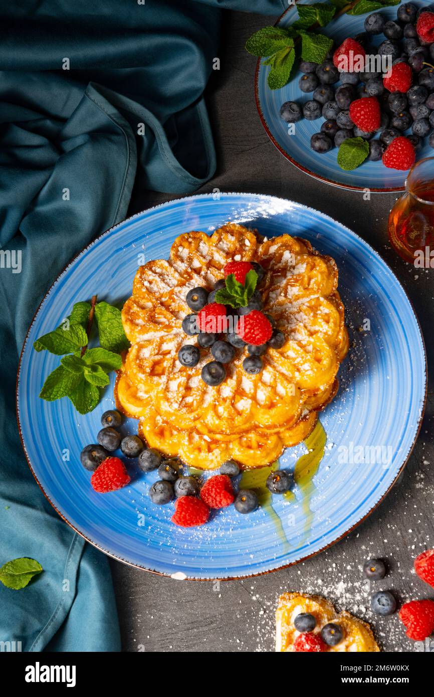 Simple sweet waffles with raspberries and blueberries Stock Photo