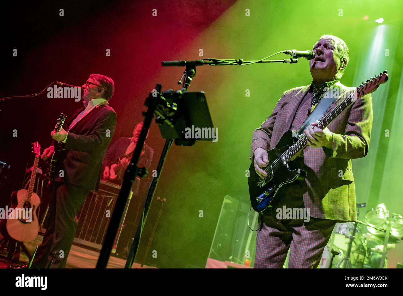 GUILDFORD, ENGLAND: Dr John Cooper Clarke and Squeeze perform on stage at G Live. Featuring: Melvin Duffy, Chris Difford, Glenn Tilbrook Where: Guildford, United Kingdom When: 29 Nov 2022 Credit: Neil Lupin/WENN Stock Photo