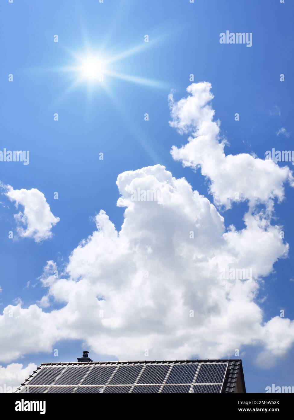 Roof with solar panels and the blue sky with clouds and sun Stock Photo ...